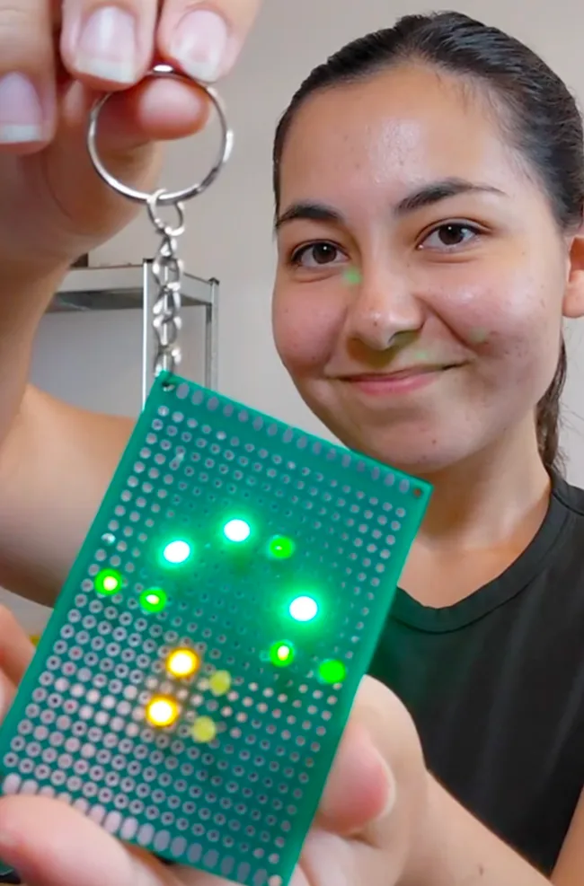 Tikita holding the illuminated mushroom LED keyring project