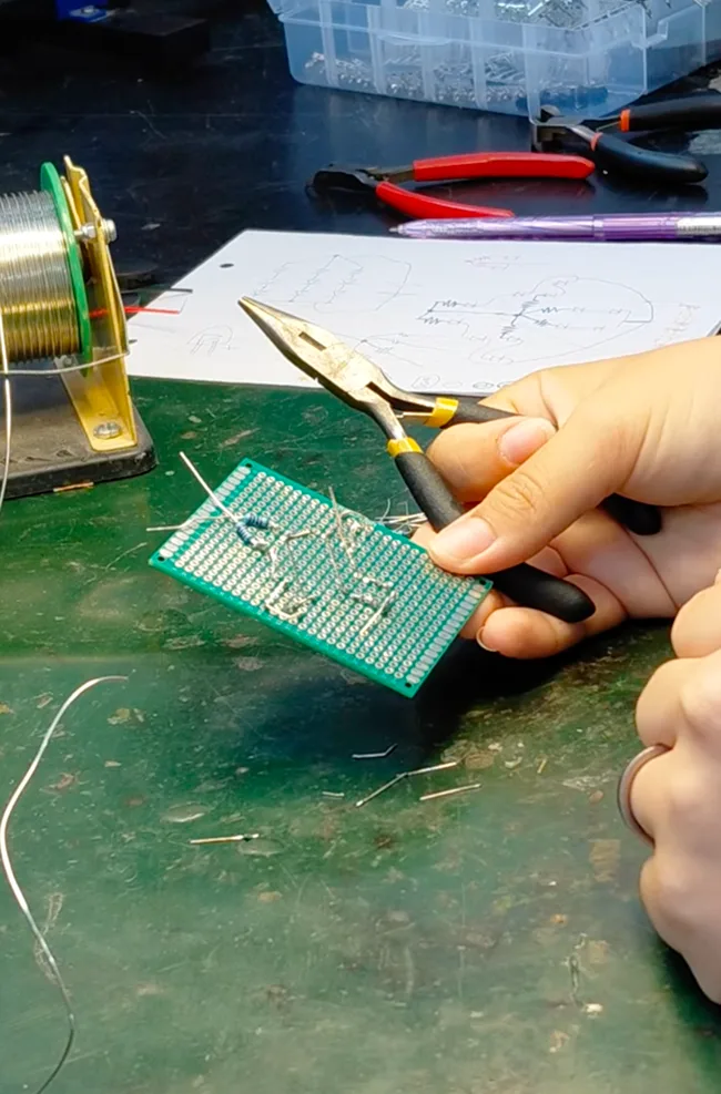 Soldering the LED keyring project being exhibited at Liverpool MakeFest 2026
